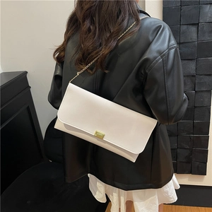 White minimalist leather crossbody bag with golden square lock and fine metal chain strap