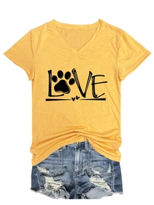 Detail of yellow V-neck T-shirt with black LOVE lettering and paw print graphic design