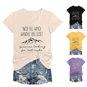 Detail showing various colors of V-neck T-shirts with mountain graphic and quote