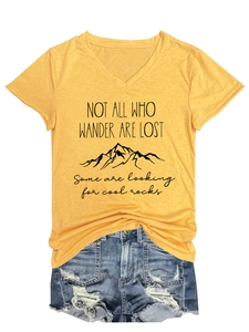 Flat lay of mustard V-neck T-shirt with mountain print and ripped denim shorts