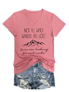 Flat lay of pink V-neck T-shirt with mountain graphic and distressed denim shorts