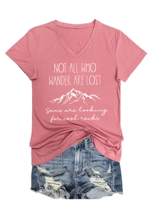 Flat lay of pink V-neck T-shirt with mountain print and ripped blue denim shorts