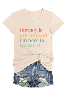 Flat lay of beige V-neck T-shirt with Literacy is my jam slogan and denim shorts
