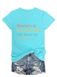 Flat lay of light blue V-neck T-shirt with literacy slogan and denim shorts