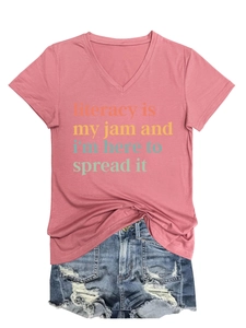 Flat lay of pink V-neck t-shirt with literacy quote and distressed denim shorts