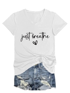 Detail of white V-neck T-shirt with just breathe heart print and distressed denim shorts