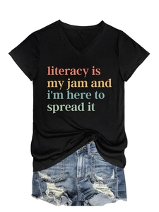 Flat lay of black V-neck T-shirt with vintage literacy text and distressed denim shorts