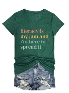 Flat lay of dark green V-neck T-shirt with literacy print and distressed denim shorts