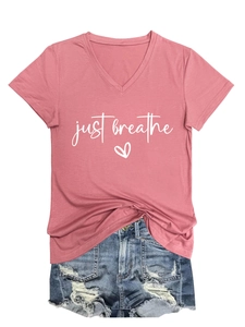 Detail of V-neck dusty pink T-shirt with just breathe heart print and ripped denim shorts