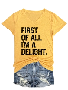 Detail of V-neck yellow cotton T-shirt with black slogan print and denim shorts