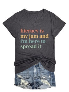 Flat lay of a grey V-neck T-shirt with literacy quote and distressed denim shorts