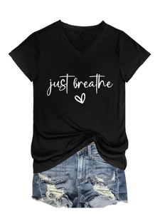 Close-up of black V-neck t-shirt with Just Breathe print and ripped denim shorts