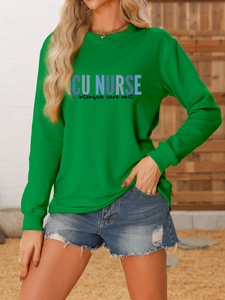 Close-up of ICU NURSE printed green crewneck sweatshirt with detailed fabric texture