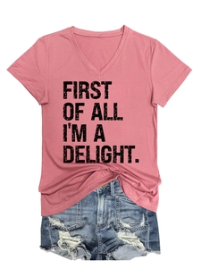 Detail of V-neck pink tee with First Of All I'm A Delight slogan and distressed denim shorts