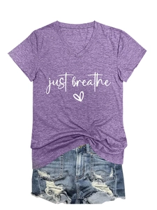 Detail of V-neck purple T-shirt featuring 'just breathe' text and heart graphic print