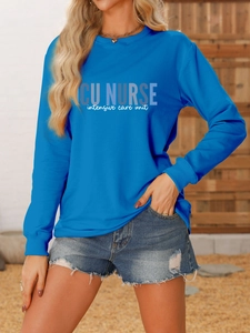 Detail of royal blue ICU Nurse sweatshirt cuff and graphic print on cotton fabric