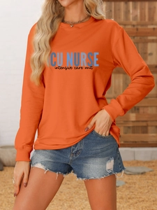 Detail of orange ICU NURSE sweatshirt showing ribbed cuffs and high-quality fabric texture