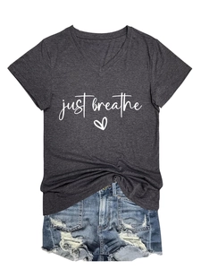 Detail of V-neck tee with 'just breathe' print and distressed denim shorts