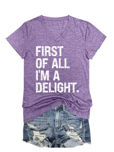 Close-up of V-neck slogan t-shirt and distressed denim shorts with frayed hems