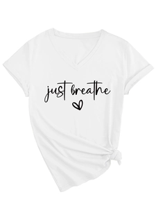 Detail of white V-neck t-shirt with Just Breathe lettering and knot front hem