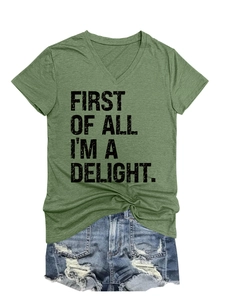 Flat lay of green V-neck T-shirt with vintage slogan and distressed denim shorts
