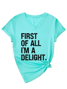 Detail of mint green V-neck T-shirt with vintage black slogan and stylish front knot