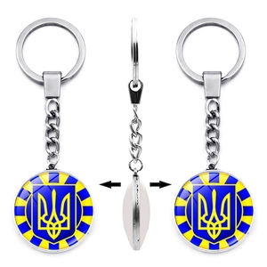 Detailed views of a double-sided Ukraine keychain with glass cabochon trident logo