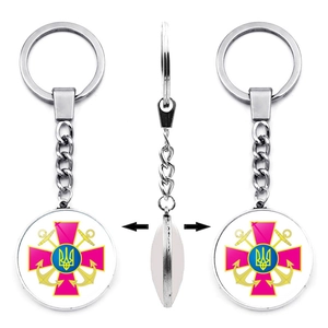 Detailed view of rotating metal keychain with double-sided Ukrainian trident emblem