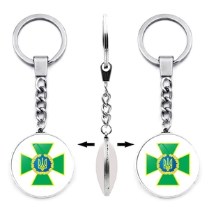 Detail of Ukraine Tryzub double-sided metal keychain showing front, side, and back views
