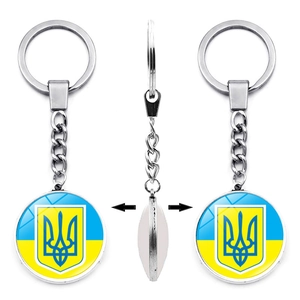 Three-way view of silver metal keychain featuring Ukraine flag and coat of arms design