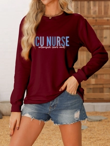 Detail showing ICU NURSE graphic print on a burgundy long sleeve crewneck sweatshirt
