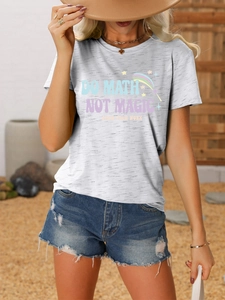 Detail of grey Do Math Not Magic t-shirt paired with distressed denim shorts outdoors