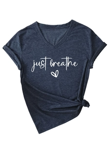 Detail of V-neck short sleeve tee featuring just breathe slogan and stylish knotted hem