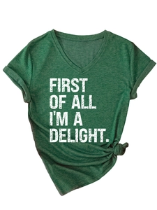 Close-up of V-neck cotton T-shirt featuring 'FIRST OF ALL I'M A DELIGHT' white slogan print
