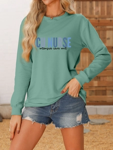 Close-up of mint green ICU NURSE print on a soft cotton long-sleeve sweatshirt