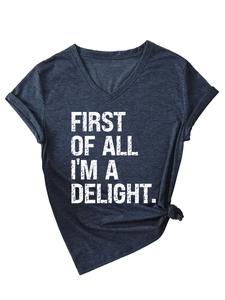 Detail of V-neck navy t-shirt featuring knotted hem and white vintage graphic print