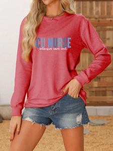 Close-up of ICU NURSE print on red crewneck sweatshirt with outdoor natural lighting