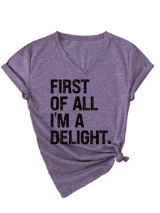 Detail of purple V-neck T-shirt with black first of all i'm a delight graphic and side knot