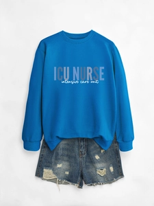 Flat lay of royal blue ICU Nurse sweatshirt paired with distressed denim shorts