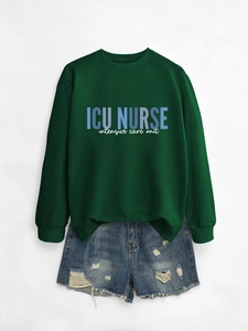 Detail of ICU NURSE text print on dark green crewneck sweatshirt and denim shorts