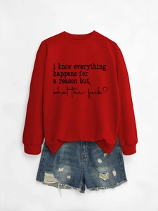 Flat lay of red sweatshirt with text and distressed blue denim shorts on white background