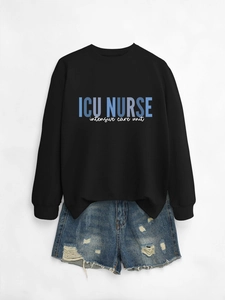 Detail view of ICU NURSE intensive care unit typography on black crewneck sweatshirt