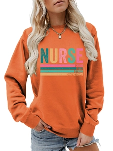 Detail of orange nurse sweatshirt featuring caring loyal strong print on cotton fabric