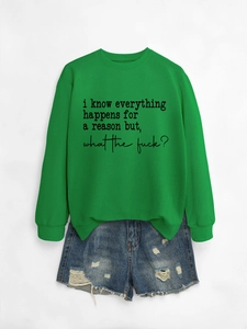 Flat lay of a green crewneck sweatshirt with text paired with distressed denim shorts
