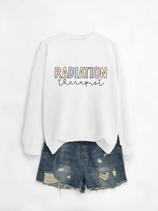 Macro detail of Radiation Therapist print on white crewneck sweatshirt with denim shorts