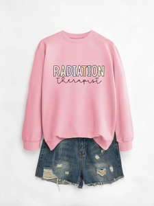 Flat lay detail of pink Radiation Therapist sweatshirt and distressed denim shorts