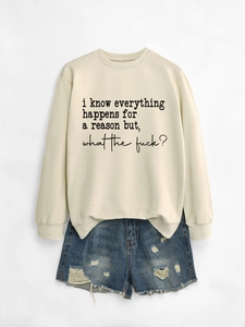 Flat lay of cream crewneck sweatshirt with handwritten slogan and distressed denim shorts