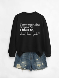 Flat lay of a black long sleeve sweatshirt with text and distressed denim shorts