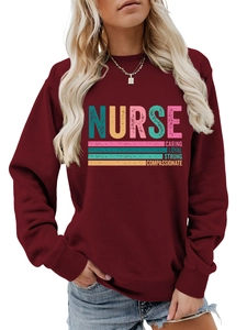 Detail of burgundy nurse sweatshirt with colorful Caring Loyal Strong text print