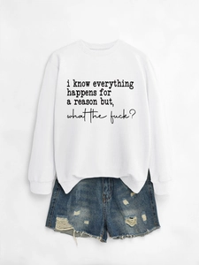 Flat lay of a white crewneck sweatshirt with text print and distressed denim shorts